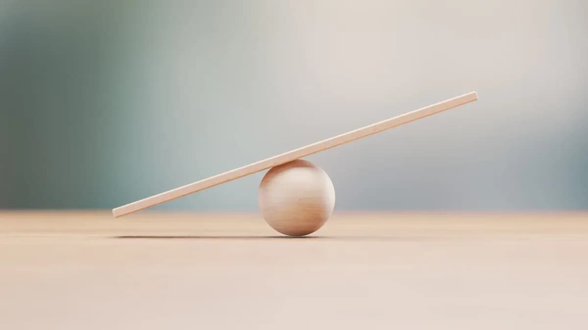 A wooden fulcrum against a blank background.