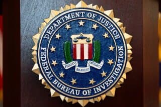 An FBI seal is displayed on a podium before a news conference at the field office in Portland, Ore., Jan. 16, 2025. (AP Photo/Jenny Kane, File)